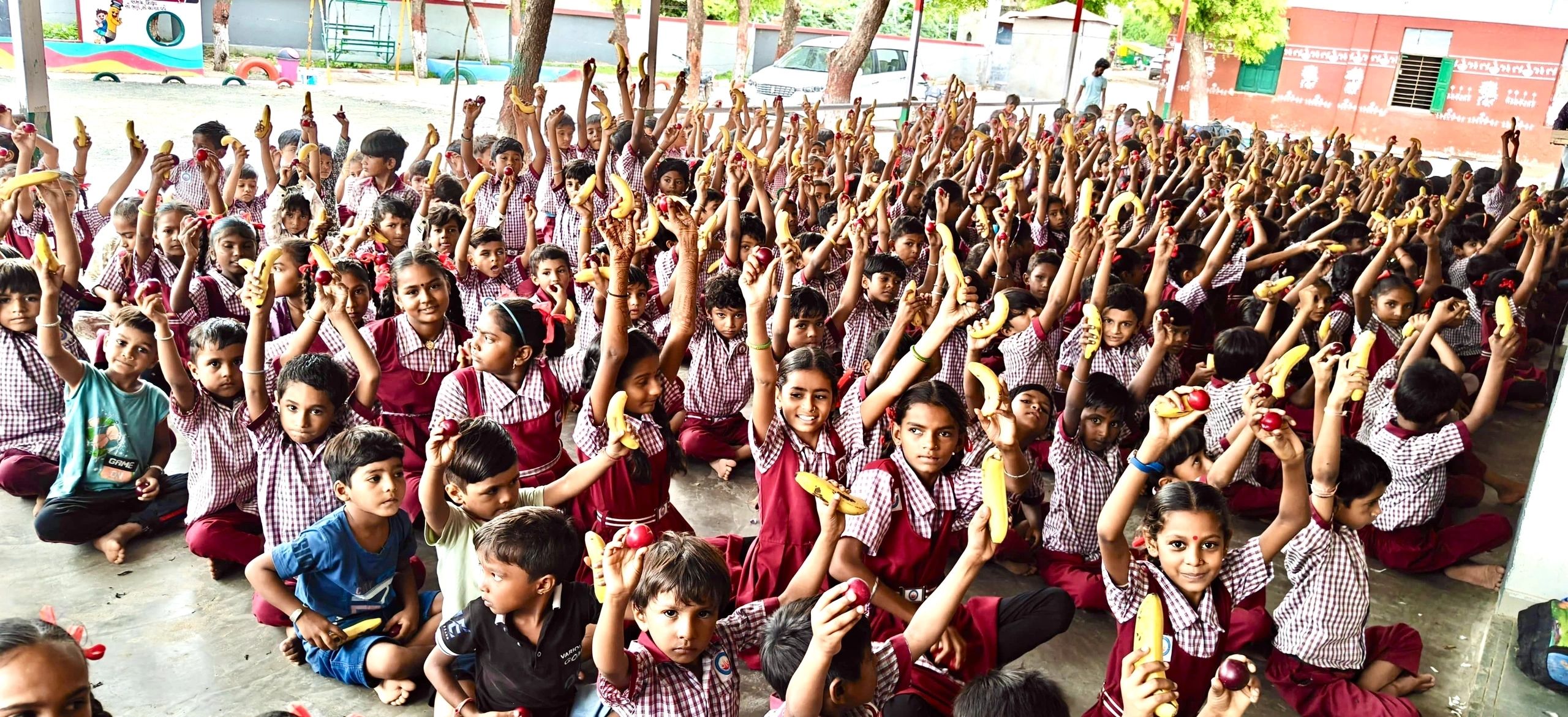 Children at Ghoda Primary School in Gujarat enjoying the Weekly Fruit Breakfast Program